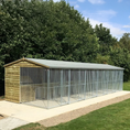 Load image into Gallery viewer, A multi-unit wooden dog kennel block with multiple runs. The structure is built with pressure-treated timber and features galvanized steel bar panels for the runs, with each unit having a separate, enclosed sleeping area. The kennel is designed for multiple dogs and is durable and secure.