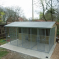 Load image into Gallery viewer, A multi-unit wooden dog kennel block with multiple runs. The structure is built with pressure-treated timber and features galvanized steel bar panels for the runs, with each unit having a separate, enclosed sleeping area. The kennel is designed for multiple dogs and is durable and secure.