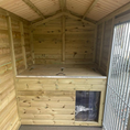 Load image into Gallery viewer, Internal view of the Buxton kennel showing the space-saving elevated sleeping cabin and draught screen