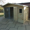 Load image into Gallery viewer, A Kennelstore 10x5 Elworth Apex Wooden Dog Kennel & Run. The pressure-treated outdoor shelter features a classic apex roof design and a secure galvanized steel run panel.