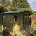 Load image into Gallery viewer, A Kennelstore 12x5 Elworth Apex Wooden Dog Kennel & Run. The pressure-treated outdoor shelter features a classic apex roof design and a secure galvanized steel run panel.