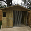 Load image into Gallery viewer, dog kennel, highlighting its weatherproof design and ability to shed rain.