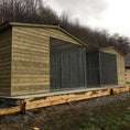 Load image into Gallery viewer, A multi-unit wooden dog kennel block with multiple runs. The structure is built with pressure-treated timber and features galvanized steel bar panels for the runs, with each unit having a separate, enclosed sleeping area. The kennel is designed for multiple dogs and is durable and secure.