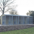 Load image into Gallery viewer, A multi-unit wooden dog kennel block with multiple runs. The structure is built with pressure-treated timber and features galvanized steel bar panels for the runs, with each unit having a separate, enclosed sleeping area. The kennel is designed for multiple dogs and is durable and secure.