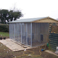 Load image into Gallery viewer, A multi-unit wooden dog kennel block with multiple runs. The structure is built with pressure-treated timber and features galvanized steel bar panels for the runs, with each unit having a separate, enclosed sleeping area. The kennel is designed for multiple dogs and is durable and secure.