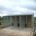 Load image into Gallery viewer, A multi-unit wooden dog kennel block with multiple runs. The structure is built with pressure-treated timber and features galvanized steel bar panels for the runs, with each unit having a separate, enclosed sleeping area. The kennel is designed for multiple dogs and is durable and secure.