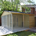 Load image into Gallery viewer, A multi-unit wooden dog kennel block with multiple runs. The structure is built with pressure-treated timber and features galvanized steel bar panels for the runs, with each unit having a separate, enclosed sleeping area. The kennel is designed for multiple dogs and is durable and secure.
