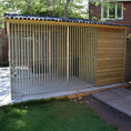 Load image into Gallery viewer, A multi-unit wooden dog kennel block with multiple runs. The structure is built with pressure-treated timber and features galvanized steel bar panels for the runs, with each unit having a separate, enclosed sleeping area. The kennel is designed for multiple dogs and is durable and secure.