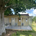 Load image into Gallery viewer, A multi-unit wooden dog kennel block with multiple runs. The structure is built with pressure-treated timber and features galvanized steel bar panels for the runs, with each unit having a separate, enclosed sleeping area. The kennel is designed for multiple dogs and is durable and secure.