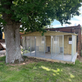 Load image into Gallery viewer, A multi-unit wooden dog kennel block with multiple runs. The structure is built with pressure-treated timber and features galvanized steel bar panels for the runs, with each unit having a separate, enclosed sleeping area. The kennel is designed for multiple dogs and is durable and secure.