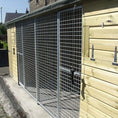 Load image into Gallery viewer, KENNELSTORE Wymbury Double Wooden Dog Kennel, a 21ft x 5ft multi-dog housing unit. The kennel features a distinctive apex roof and is made from pressure-treated tanalised timber, with two separate runs equipped with galvanised panels for security.