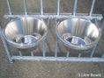 Load image into Gallery viewer, Double wall-mounted dog bowls clipped securely to galvanised bar panel in kennel