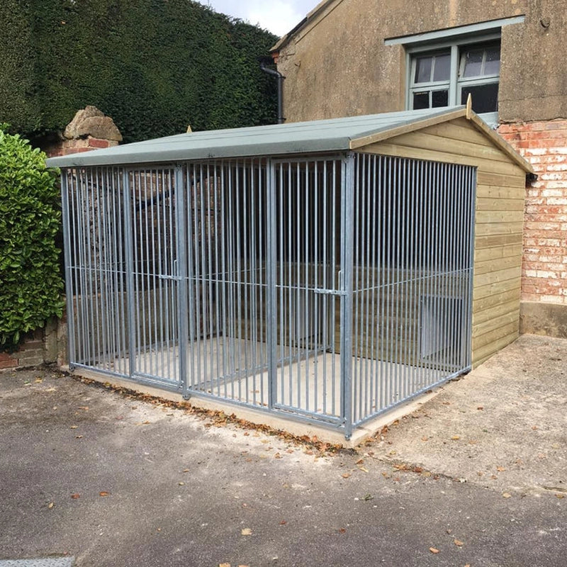 A multi-unit wooden dog kennel block with multiple runs. The structure is built with pressure-treated timber and features galvanized steel bar panels for the runs, with each unit having a separate, enclosed sleeping area. The kennel is designed for multiple dogs and is durable and secure.