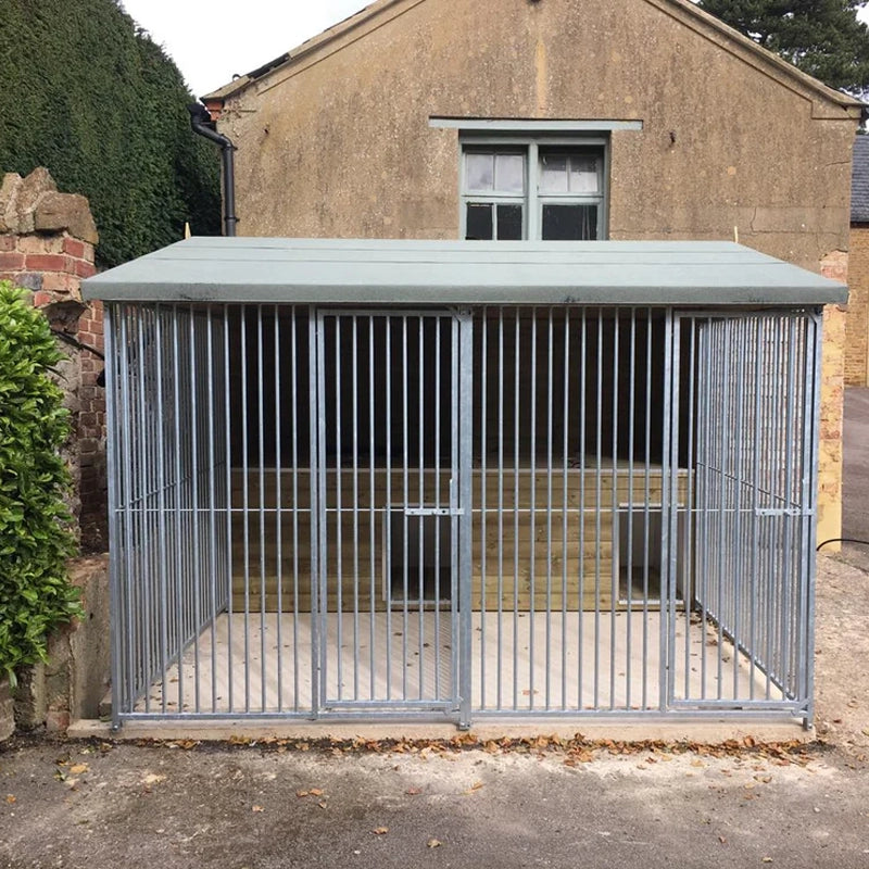 A multi-unit wooden dog kennel block with multiple runs. The structure is built with pressure-treated timber and features galvanized steel bar panels for the runs, with each unit having a separate, enclosed sleeping area. The kennel is designed for multiple dogs and is durable and secure.