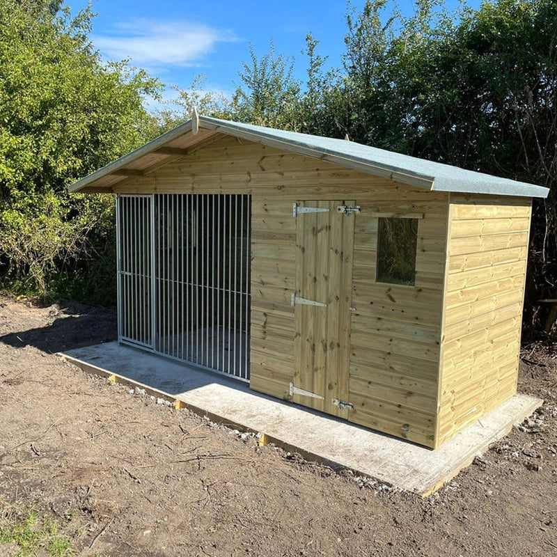 A Kennelstore 12x5 Elworth Apex Wooden Dog Kennel & Run. The pressure-treated outdoor shelter features a classic apex roof design and a secure galvanized steel run panel.