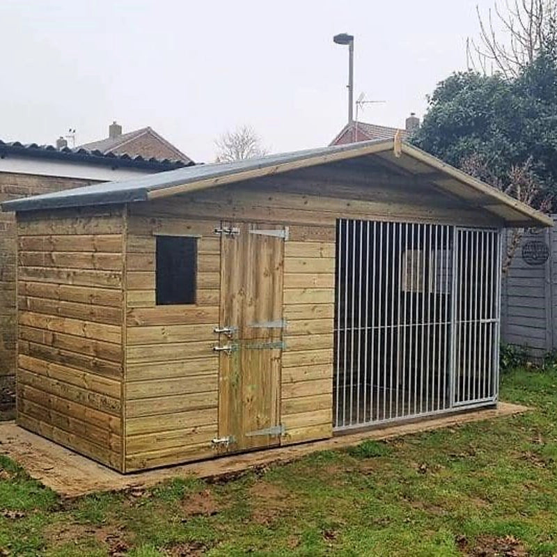 A Kennelstore 12x6 Elworth Apex Wooden Dog Kennel & Run. The pressure-treated outdoor shelter features a classic apex roof design and a secure galvanized steel run panel.