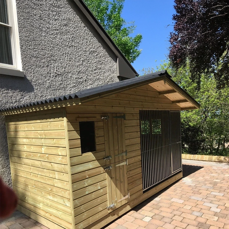 A Kennelstore 12x5 Elworth Apex Wooden Dog Kennel & Run. The pressure-treated outdoor shelter features a classic apex roof design and a secure galvanized steel run panel.