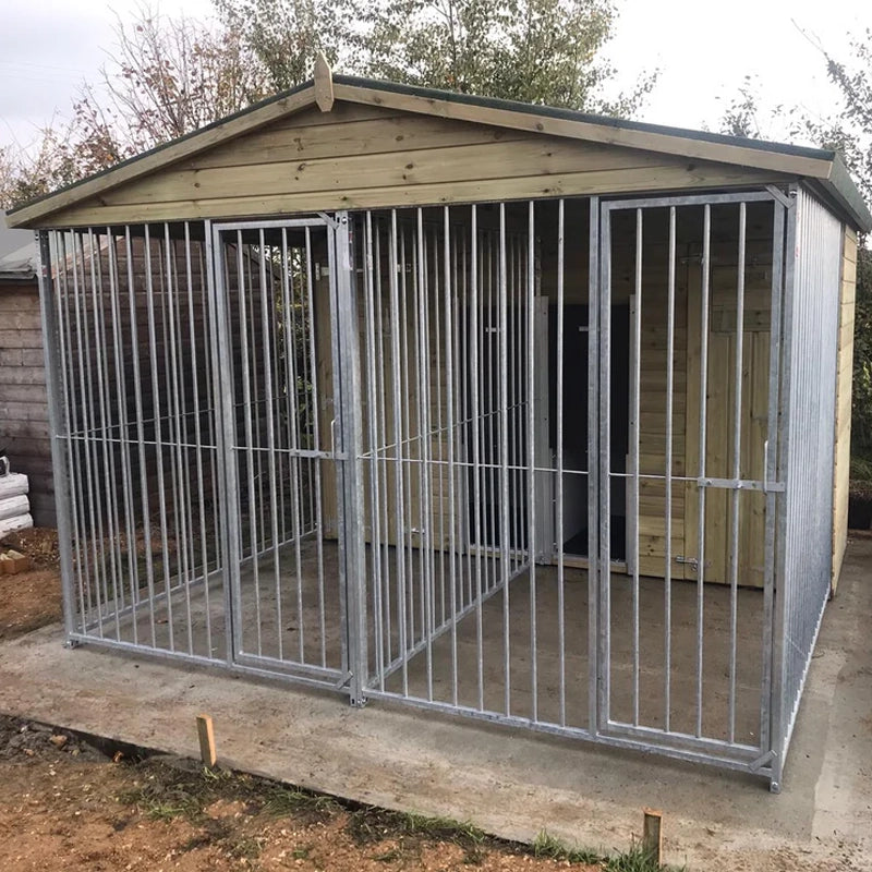 A large, 6x9 wooden Kennelstore Wymbury Double Dog Kennel and Run, featuring a classic apex roof. The kennel is constructed with durable, pressure-treated tanalised timber and includes galvanised steel panels, making it ideal for housing and separating multiple dogs securely.