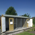Load image into Gallery viewer, KENNELSTORE Wymbury Double Wooden Dog Kennel, a 18ft x 5ft multi-dog housing unit. The kennel features a distinctive apex roof and is made from pressure-treated tanalised timber, with two separate runs equipped with galvanised panels for security.
