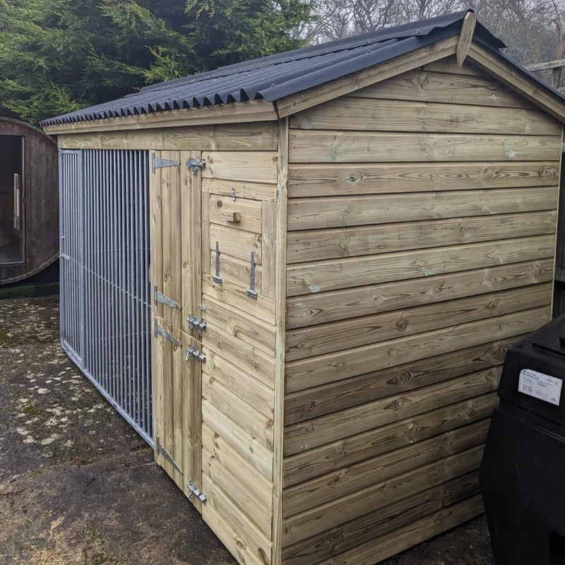 A Kennelstore 14x5 Wymbury Wooden Dog Kennel and Run. The spacious outdoor shelter is built with durable timber to provide a secure and comfortable home for a dog.