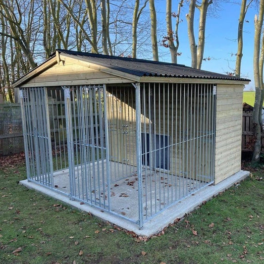 A large, 10x6 wooden Kennelstore Wymbury Double Dog Kennel and Run, featuring a classic apex roof. The kennel is constructed with durable, pressure-treated tanalised timber and includes galvanised steel panels, making it ideal for housing and separating multiple dogs securely.