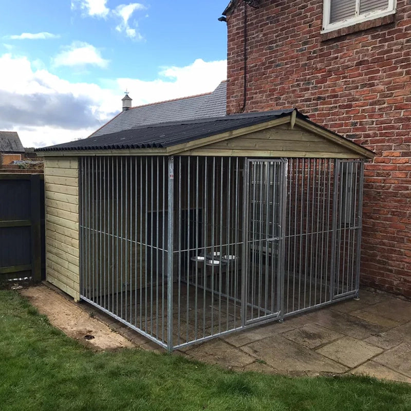 A large, 6x9 wooden Kennelstore Wymbury Double Dog Kennel and Run, featuring a classic apex roof. The kennel is constructed with durable, pressure-treated tanalised timber and includes galvanised steel panels, making it ideal for housing and separating multiple dogs securely.